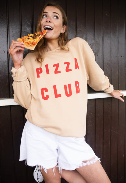 Model wears nude sweatshirt with Pizza Club slogan 