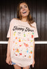 Model wears dusty peach tshirt with Happy Hour Cocktail guide graphic