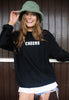 Model wears black sweatshirt with Cheers slogan