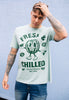 model wears dusty green tee with so fresh and chilled slogan print  