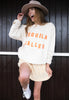 Model wears vanilla sweatshirt with Tequila Called printed slogan