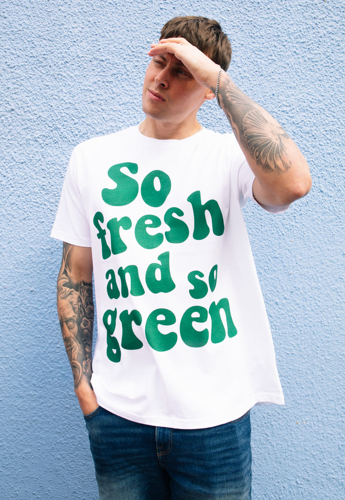 model wears white tshirt with printed green slogan 