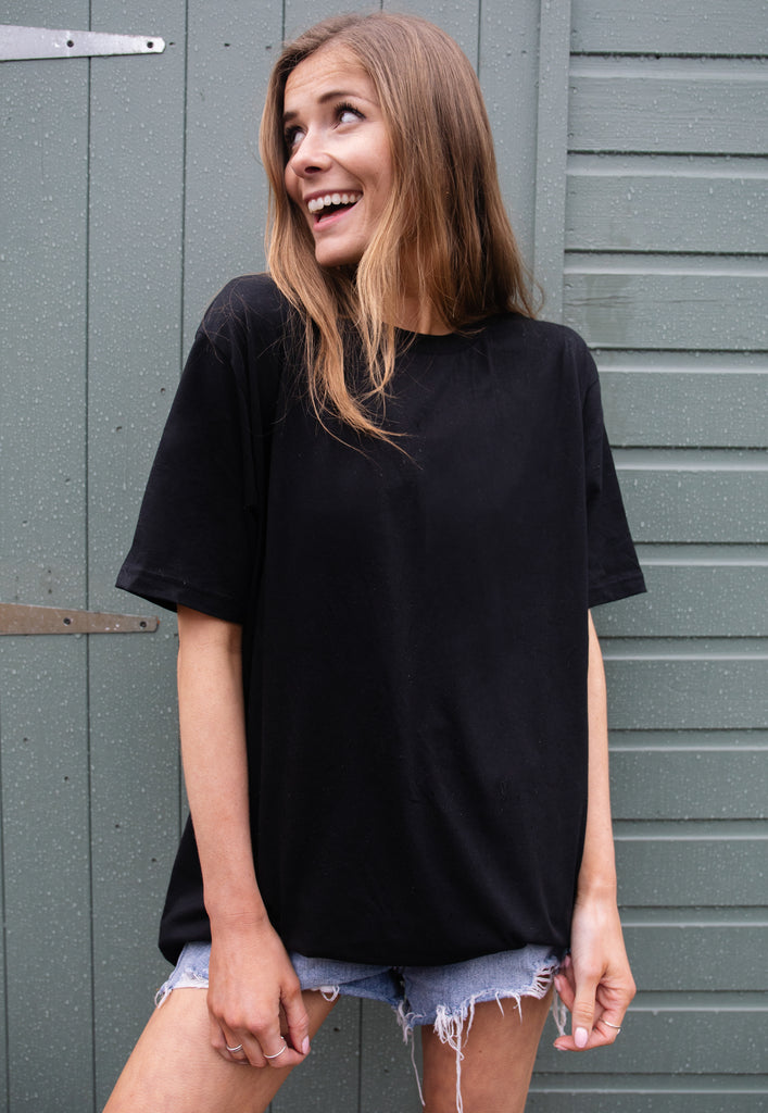 model wears black tshirt with Garden Beats festival graphic 
