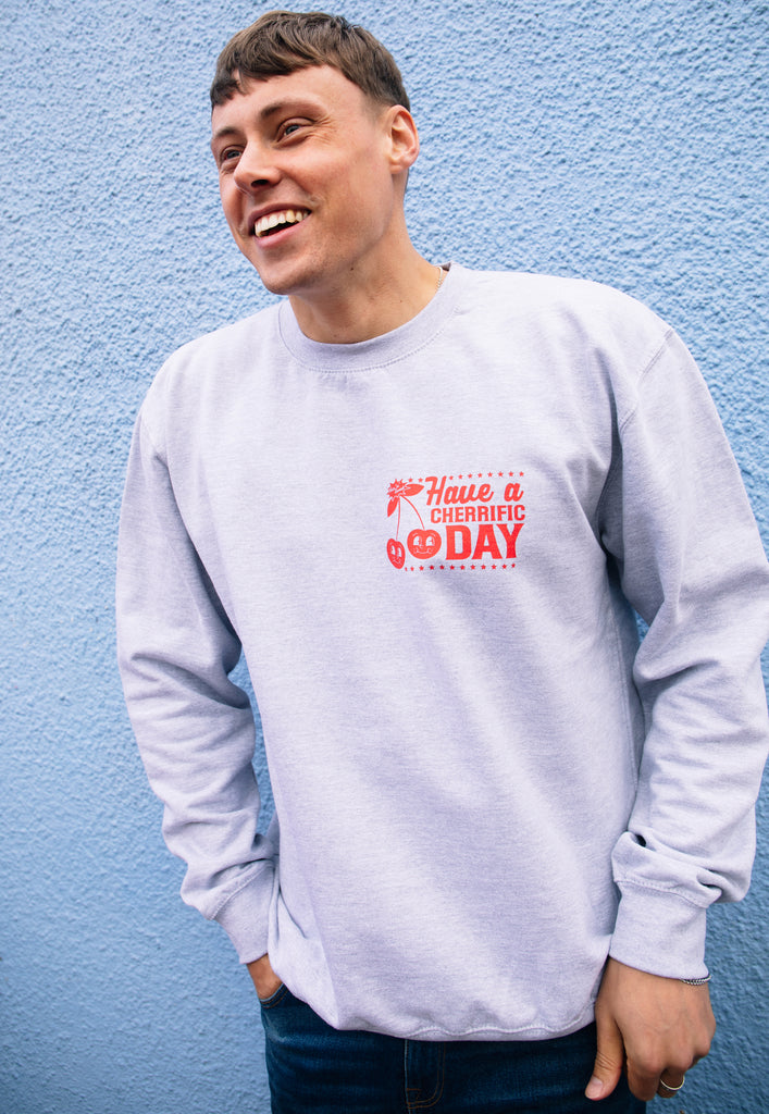 Model wears grey sweatshirt with have a cherrific day front print 