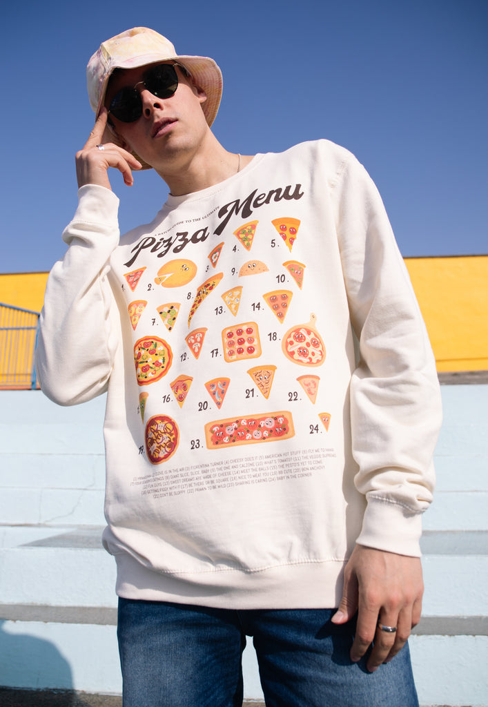 Model wears graphic print on vanilla sweatshirt