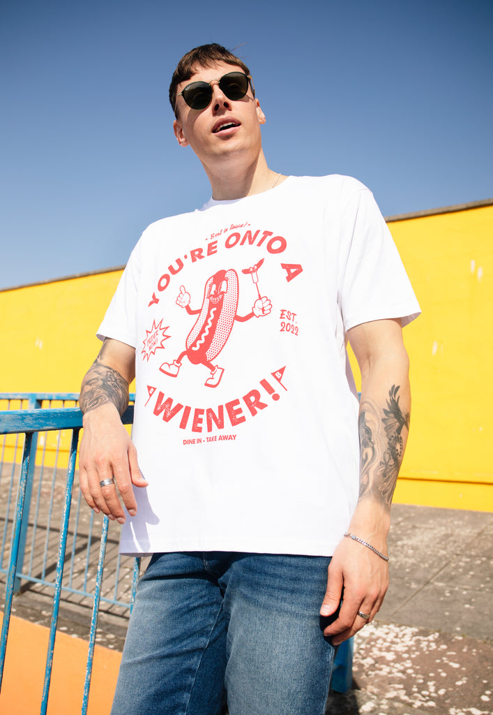 male model is wearing white t shirt with vintage style hot dog character and funny slogan