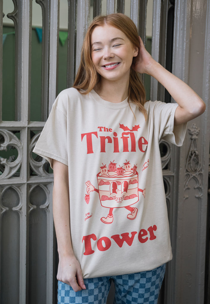 Female model wears trifle tower christmas slogan t-shirt with vintage style character print