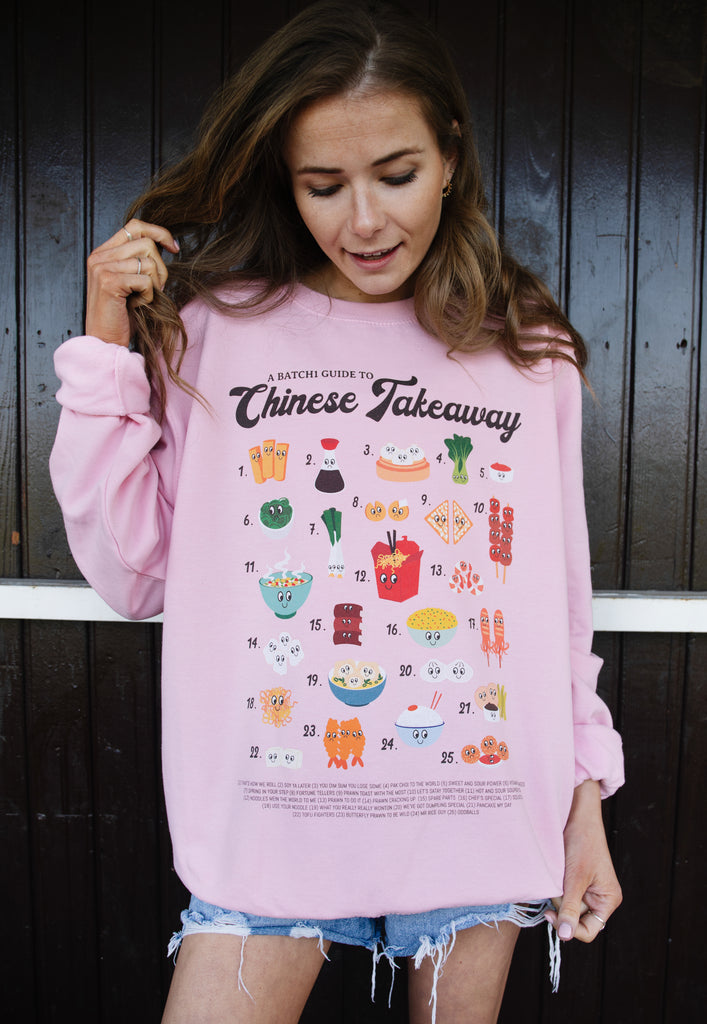 Model wears pink sweatshirt with Chinese takeaway graphic 