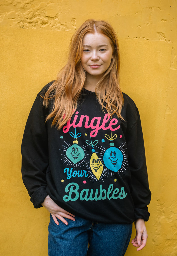 women's black christmas jumper with festive baubles in bright pastel print