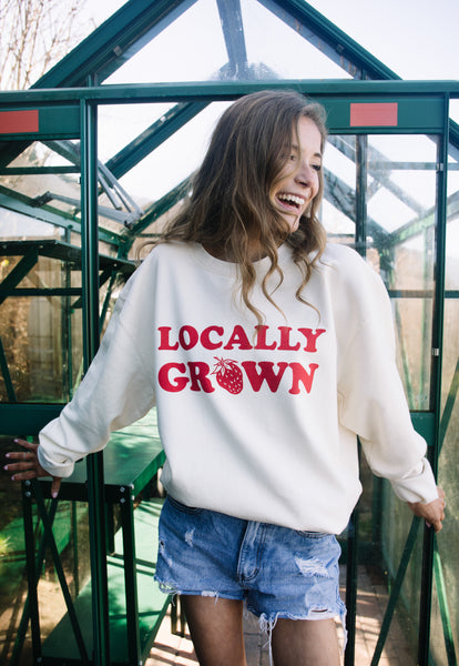 Model wears strawberry printed slogan jumper