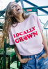Model wears pink tshirt with locally grown slogan 