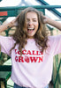 Model wears pink tshirt with locally grown graphic print
