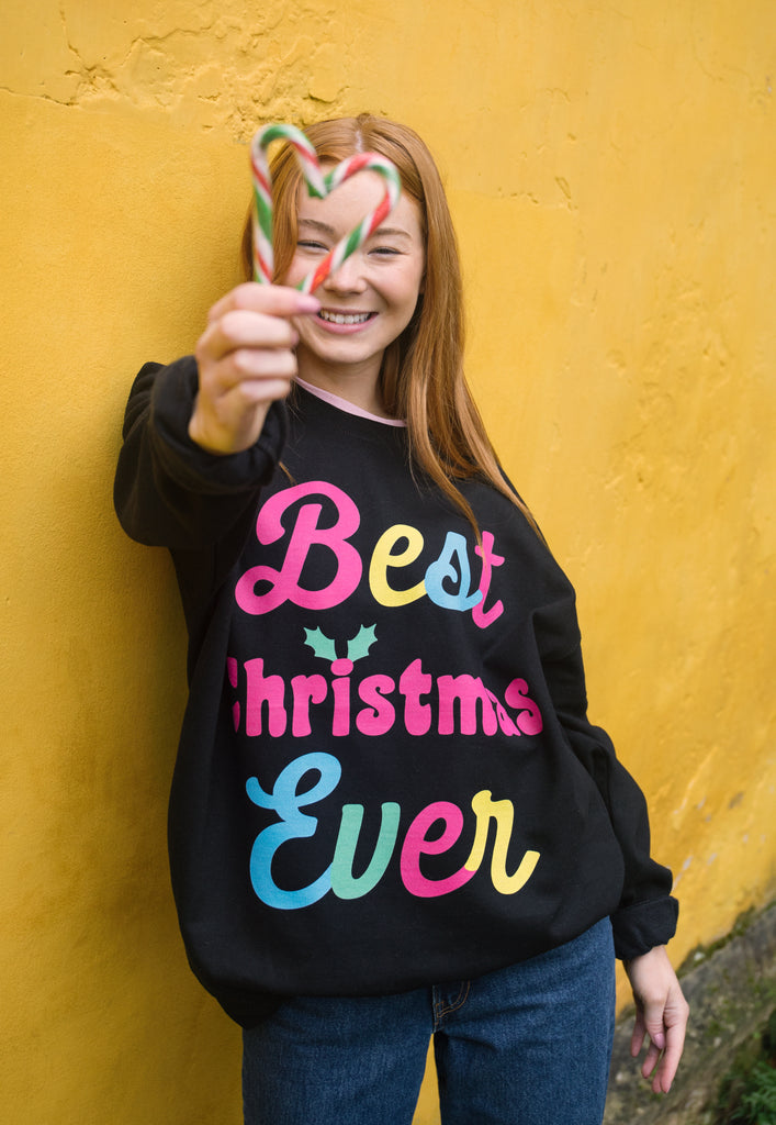 cute christmas jumper with neon bright festive slogan