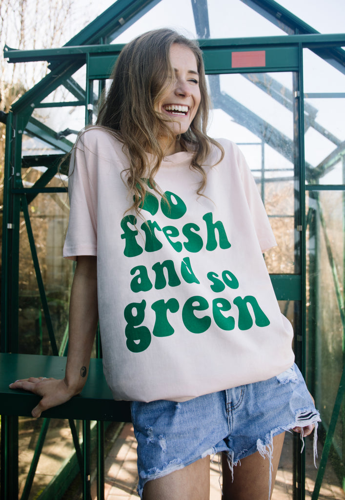 Model wears graphic tshirt with so fresh and so green slogan 