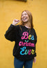 christmas slogan sweater in black with colourful christmas slogan