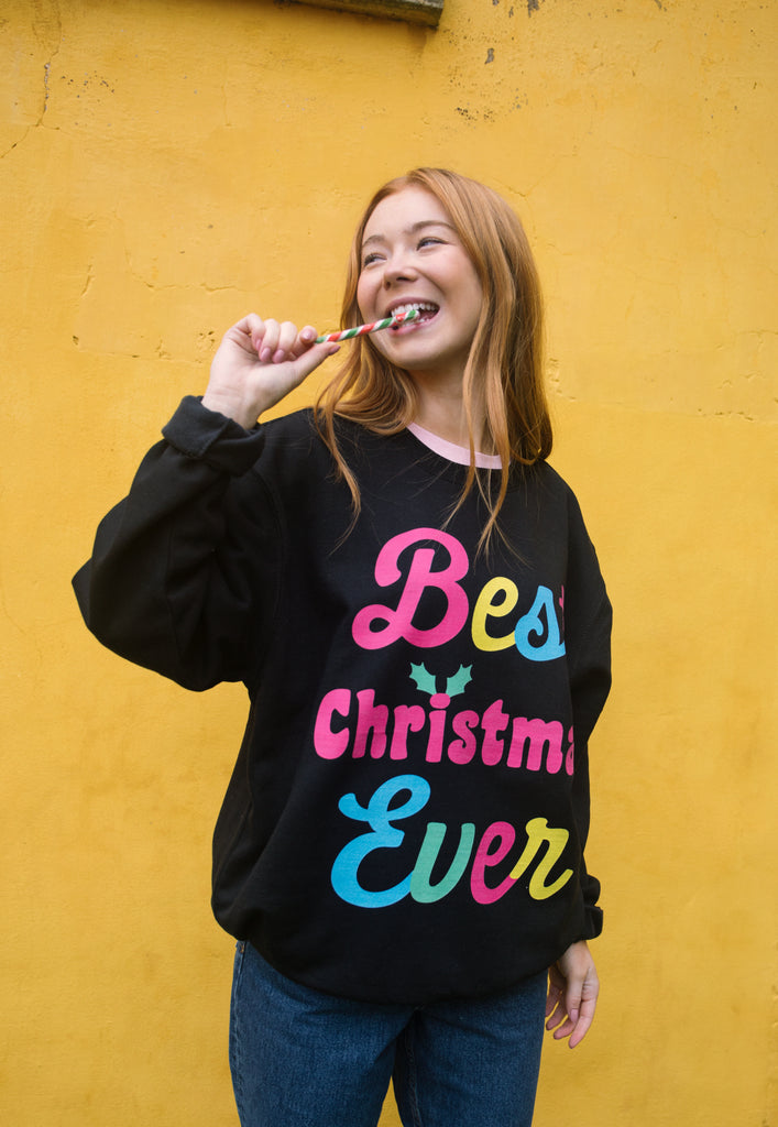 christmas slogan sweater in black with colourful christmas slogan