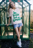 model wears dusty peach tshirt with printed slogan 