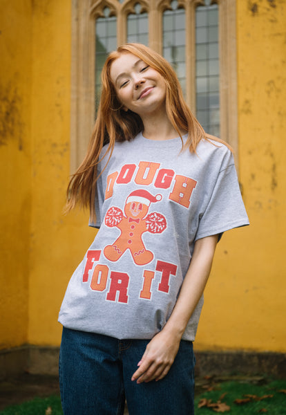 female model wears positive christmas t shirt with cheerleading gingerbread man graphic