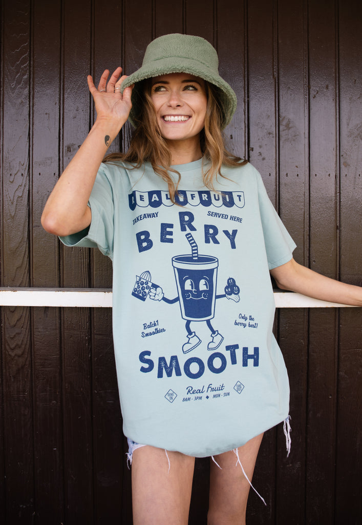 Model wears dusty green tshirt with berry smooth slogan