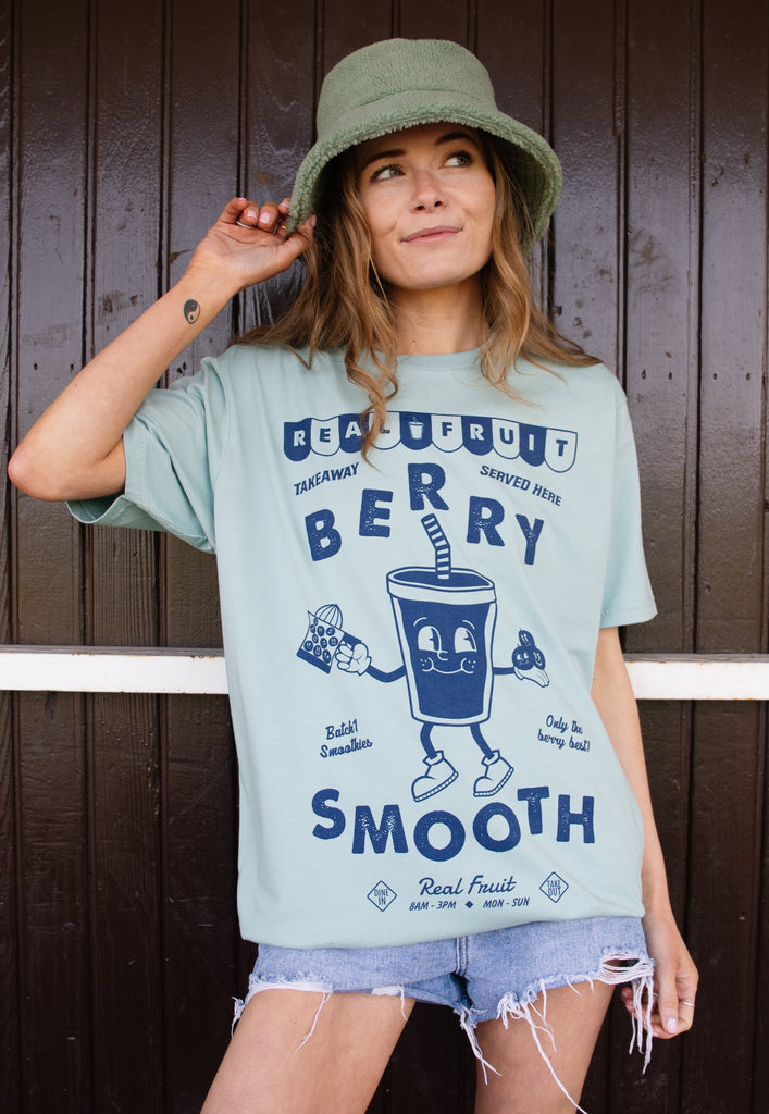 Model wears dusty green tshirt with berry smooth graphic 
