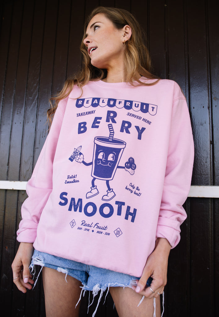 Model wears pink sweatshirt with berry smooth slogan 
