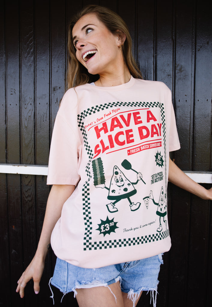 Model wears dusty peach t-shirt with vintage pizza graphic