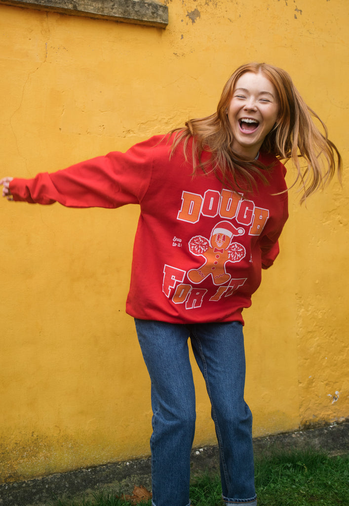 red womens sweater with dough for it slogan in college lettering