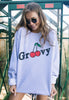 Model wears grey sweatshirt with groovy printed cherry slogan