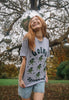 female model wears christmas brussels sprouts t-shirt with 'going sprout out' slogan and dancing sprouts print