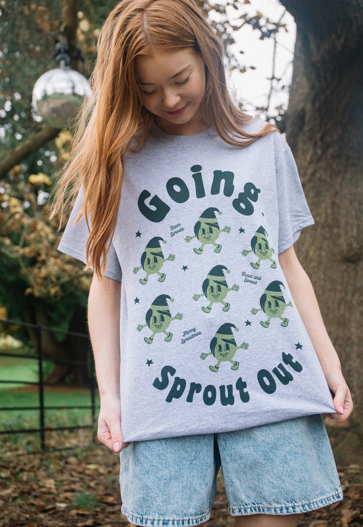 female model wears christmas t shirt in grey with vintage style sprout characters dancing and punny slogan