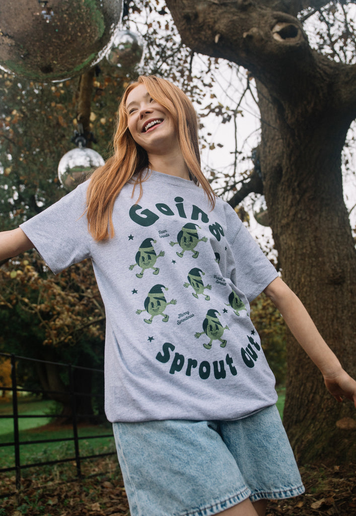 female model is wearing unisex fit fun christmas t shirt with brussels sprout theme and vintage character print