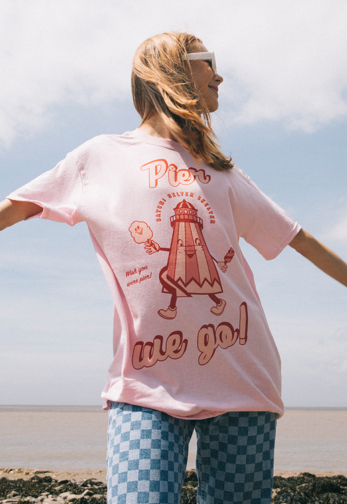 Pink t shirt with British seaside slogan and vintage style funfair graphic