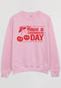 Flatlay of pink sweater with printed cherry logo on front and cherry pun slogan