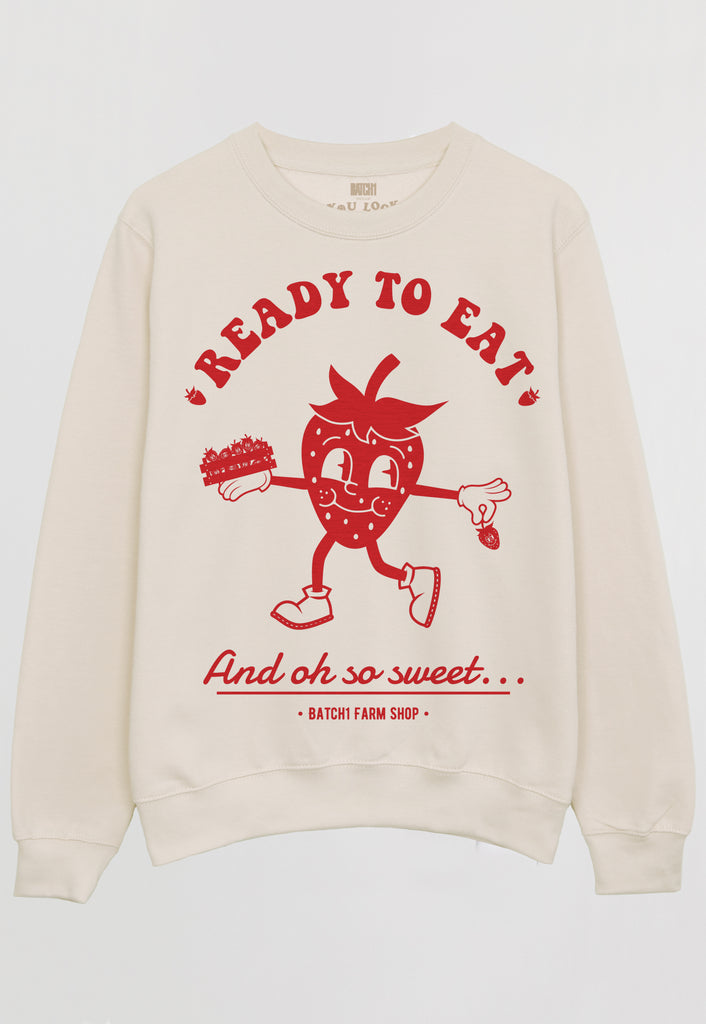 flatlay of vanilla sweatshirt with ready to eat strawberry graphic print 