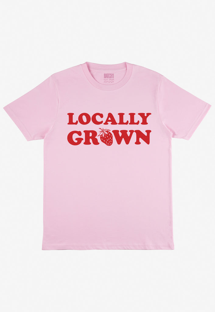 Flatlay of pink tshirt with locally grown printed slogan 