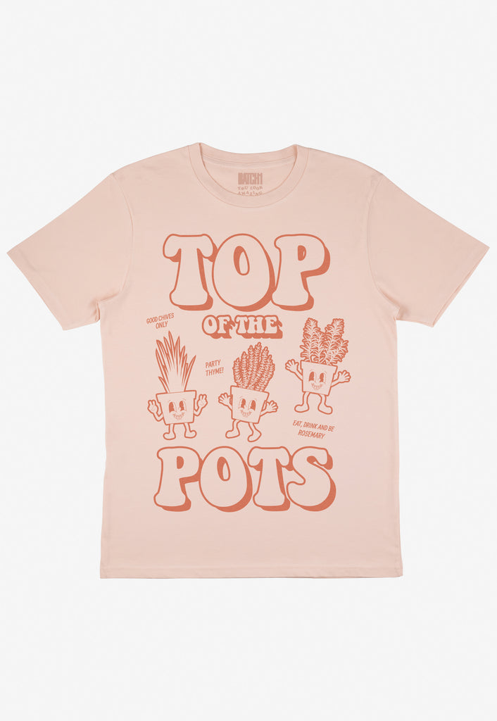 Flatlay of dusty peach tshirt with Top of the Pots slogan and 70s style plant pot character graphic 