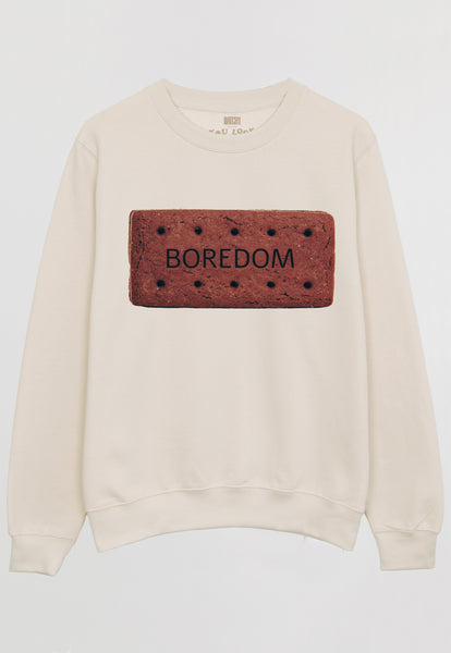 Flatlay of women's sweatshirt with "Boredom" slogan and biscuit graphic