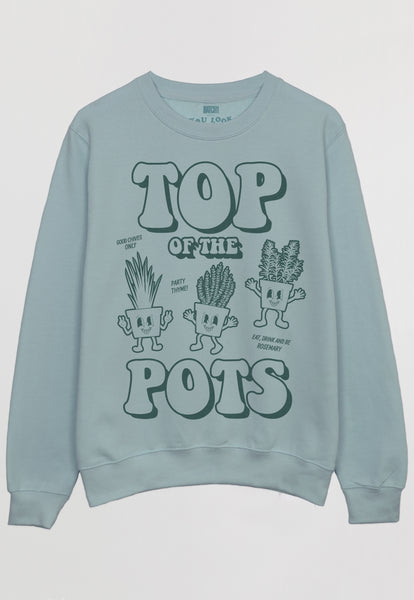 Flatlay of dusty green sweatshirt with Top of The Pots festival slogan and plant pot character graphic