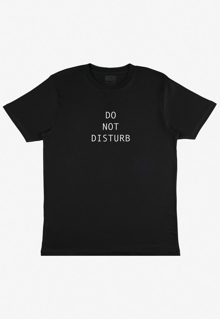 Flatlay of unisex fit black t-shirt with Do Not Disturb slogan printed in white text