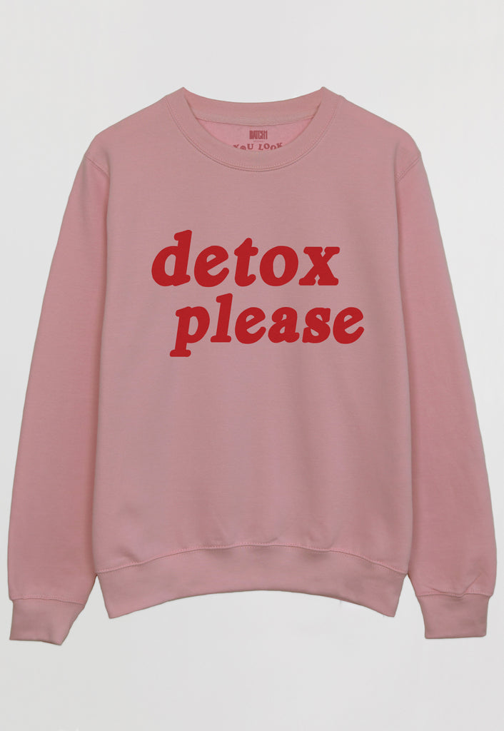 Flatlay of dusty pink printed sweatshirt with Detox slogan in red text
