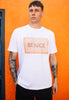 Model wears white tshirt with Be Nice slogan and biscuit graphic 