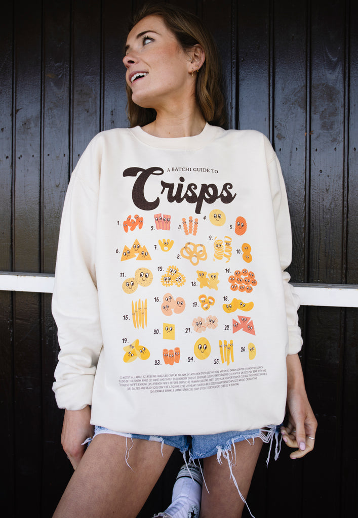 Model wears vanilla sweatshirt with printed Crisps guide and fun crips character graphics